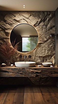 a bathroom with two sinks and a round mirror