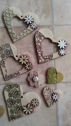 some heart shaped cookies sitting on top of a tile floor next to flowers and hearts