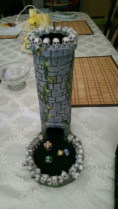 a table topped with a tall vase filled with skulls