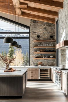 an open kitchen with stone walls and wood ceilinging, along with large windows that look out onto the mountains