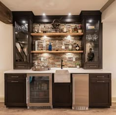 a kitchen with an oven, sink and shelves filled with wine glasses on the wall