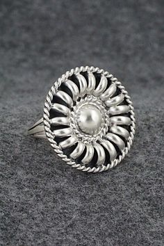 This satin finish sterling silver ring was made by Navajo silversmith Manuel Johnson.Size: 8Length: 1 1/8"Width: 1 1/8"Free shipping on all orders! We ship with USPS and always include tracking. All orders ship within a day of payment.Returns are accepted up to 30 days after you receive your order. Just send us a message. Our shop offers cash back or store credit. The item must be returned in new condition. Nickel-free Silver Rings In Southwestern Style, Nickel-free Silver Southwestern Rings, Nickel-free Southwestern Silver Rings, Southwestern Style Nickel-free Silver Rings, Western Style Sterling Silver Rings In Silver, Western Style Sterling Silver Rings, Artisan Silver Ring With Concho, Adjustable Silver Concho Rings, Unique Silver Ring With Concho Detail