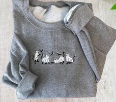 Adorable sweatshirt featuring ghost cats!   Unisex sweatshirt offers a relaxed fit for all genders and body types. Comfortable and warm which is perfect for fall nights and Halloween fun. INFORMATION * Gildan Unisex Sweatshirt * 50% Cotton, 50% Polyester -Design is embroidered with high quality thread CARE INSTRUCTIONS Machine wash cold on delicate cycle, dry low heat or lay flat to dry. Do not bleach/dry clean.  SIZING Unisex sized.  Please refer to guide size photo to determine the most accurate fit & for all measurements and information. SHIPPING We require 3-5 days for processing time- Rush option is available. Please contact me to discuss. Please allow another 2-10 days for delivery. Please ensure your selections are correct as I do not accept returns. Size Chart S M L XL 2XL Fall Crew Neck Sweater With Cat Design, Crew Neck Sweater With Cat Design For Fall, Cotton Cat Design Tops For Fall, Cotton Cat Design Top For Fall, Cotton Tops With Cat Design For Fall, Cotton Top With Cat Design For Fall, Fall Cotton Sweater With Cat Print, Cat Design Cotton Long Sleeve Sweatshirt, Fall Crew Neck Sweatshirt With Cat Design