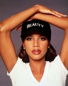 a woman wearing a hat with the word beauty on it