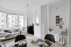 a living room filled with furniture and lots of windows