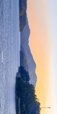 the water is calm and clear at sunset