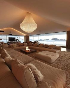 a living room filled with lots of couches and a fire place in the middle