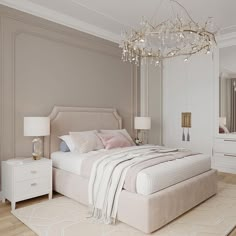 a bedroom with a large bed and a chandelier