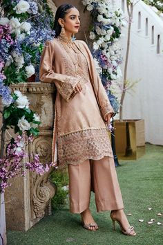 Peach Color Embroidered Kameez Trousers Pakistani Eid Dress is the epitome of tradition and royalty that will give you a head-turning look on the festive occasion. This beautiful Dress will steal everyone's hearts at the very first glance by its lavish designs and premium fabric. Detailed Description: SKU: PB0087 Detailing: Embroidery, Threads, Floral designs Color: Peach Fabric: Jacquard Design: Fully Embroidered dress Event: Festive, Party wear Pakistani Boutique, Eid Dress, Pakistani Designer Clothes, Peach Fabric, Eid Dresses, Dyed Silk, Silk Trousers, Pakistani Designers, 3 Piece Suits