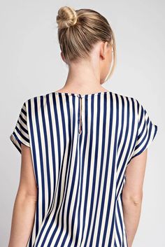 STRIPED CAP SLEEVE BLOUSE TOPStripe printed short sleeve blouse top featuring a rounded neckline, cap sleeves, a button and keyhole closure in the back and is a lightweight top perfect for the Spring season. 100% POLYESTER Measurements: Bust: small 44", medium 46", large 48" Length: small 26", medium 26.5", large 27" Short Sleeve Vertical Stripes Blouse For Work, Spring Short Sleeve Blouse With Vertical Stripes, Short Sleeve Vertical Stripe Workwear Blouse, Spring Blouse With Vertical Stripes And Short Sleeves, Chic Cap Sleeve Tops For Summer, Summer Workwear Tops With Vertical Stripes, Chic Striped Short Sleeve T-shirt, Chic Striped Short Sleeve Tops, Chic Striped Short Sleeve Blouse