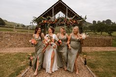 Fun wedding party photo with the bridesmaid in green wrap dresses holding orange wedding bouquets Wedding Platform, Blue Bridesmaid Dresses Short, Orange Wedding Bouquet, Watters Wedding Dress, Watters Bridal, Indian Bridesmaid Dresses, Sage Green Dress, Bridesmaid Dresses With Sleeves, Groomsmen Outfits