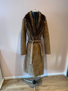 Vintage 1970's brown suede and faux fur trench coat, afghan coat, UK 8 A vintage 70's long suede trench coat with a faux fur collar. Fastens with a suede belt. UK Size 8. Please check measurements: Chest - 96cm Waist - 84cm Hips - 104cm Length - 115cm Fitted Long Fur Coat With Faux Fur Lining, Long Fitted Fur Coat With Faux Fur Lining, Suede Fur Coat For Fall, Long Fitted Outerwear With Faux Fur Lining, Fitted Long Fur Coat For Winter, Long Sleeve Suede Fur Coat For Winter, Fitted Long Outerwear With Faux Fur Lining, Winter Suede Fur Coat With Long Sleeves, Brown Fur Coat With Faux Fur Lining For Spring