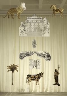 an image of animals on display in front of curtains