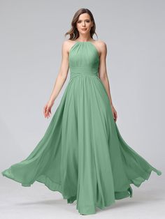 a woman wearing a long green bridesmaid dress with one shoulder and pleaed skirt