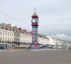 a large clock tower in the middle of a street