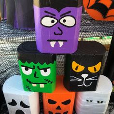 halloween decorations made out of toilet paper rolls with faces and mouths painted on the sides