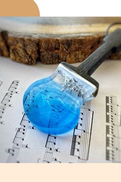 a blue object sitting on top of sheet music