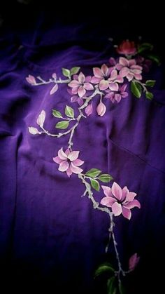 a purple cloth with pink flowers on it