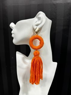 Made from dense, soft yarn, these statement earrings feature a bold ring and flowing tassel design. Available in multiple colors, they are perfect for adding a playful, yet sophisticated flair to any outfit. Trendy Tassel Dangle Earrings, Trendy Fringe Earrings, Trendy Tassel Fringe Drop Earrings, Trendy Tassel Drop Earrings With Fringe, Trendy Tassel Drop Earrings, Trendy Tassel Earrings, Chic Dangle Tassel Earrings, Yarn Tassel, Fluffy Yarn