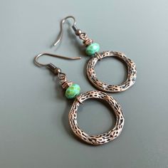 "Copper and Turquoise Hoop Earrings - Textured Antiqued Copper plated Pewter Hoops dangle from Czech Faceted Glass Turquoise Rondelle Beads with a Picasso finish and Small Copper Beads. Hoops are just over .75\" in diameter (size of US nickel) Antiqued Copper Earwires Earrings measure 2\" from top of earwires to bottom hoops." Copper Drop Hoop Earrings As Gift, Green Bohemian Hoop Earrings Hypoallergenic, Bohemian Green Hoop Earrings Hypoallergenic, Bohemian Green Hypoallergenic Hoop Earrings, Green Metal Hoop Earrings As A Gift, Turquoise Metal Hoop Earrings, Copper Hoop Earrings For Gift, Copper Circle Earrings For Gifts, Turquoise Round Copper Earrings