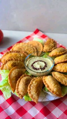 an appetizer platter with onion rings and dip