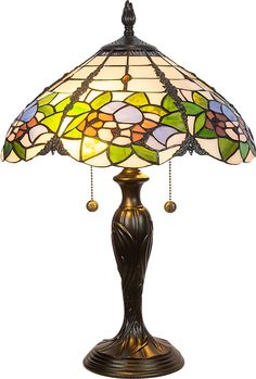 a lamp that is sitting on top of a table with a flower design on it