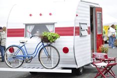 a blue bicycle is parked next to a trailer