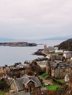 an aerial view of some buildings near the water