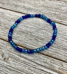 a blue beaded bracelet on a wooden surface