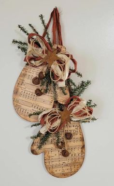 two wooden christmas stockings hanging on a wall with sheet music notes and pine cones tied to them