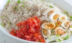 a white bowl filled with rice and veggies