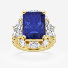 a blue and white diamond ring with three diamonds on the sides, set in yellow gold