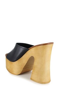 A woodgrain platform and soaring block heel lend scene-stealing height and retro-cool appeal to a slide sandal that will elevate your trendsetting looks. 4" heel; 2" platform Leather upper and lining/synthetic sole Made in Spain Black Clogs With Sculpted High Heel, Modern High Heel Clogs With Deep Heel Cup, Modern High Heel Clogs With Sculpted Heel, Modern Platform Clogs With Open Heel, Summer Wooden Stacked Heel Heels, Summer Clogs With Contrasting Heel Counter And Round Toe, Modern Clogs With Wooden Wedge Heel, Spring High Heel Platform Slippers With Wooden Heel, Spring Platform Slippers With Wooden High Heel