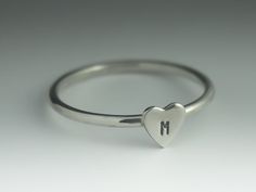 This ring is handmade from 1.5mm sterling silver wire with a 5mm sterling silver monogrammed heart. The ring is perfect for stacking. You can wear it as a solitaire ring, or pair it with other rings. Available in a shiny finish (Polished), or a matte finish (Brushed) or an oxidized and brushed finish (for a rustic look). The ring will be sent in a box, ready to be given as a gift. Made to order in your size within 3-5 business days. Ring size can be specified using halves and quarters as I hand Personalized Heart-shaped Sterling Silver Initial Ring, Personalized Open Heart Sterling Silver Ring, Personalized Sterling Silver Stackable Rings For Valentine's Day, Everyday Personalized Heart Ring, Monogram Hearts, Sterling Silver Toe Rings, Identity Crisis, Silver Monogram, Silver Heart Ring