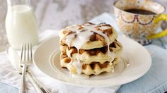 a stack of waffles covered in icing on a plate