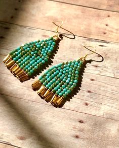 "Beautiful handmade earrings with a combination of two-color, Turquoise and gold color glass beads hanging from the gold plated ear wires Very chic and elegant.  Unique style. **Earrings are measured 2 3/4\" from ear wires to the end of the fringes." Turquoise Dangling Bead Drop Earrings, Turquoise Czech Glass Beaded Earrings, Turquoise Teardrop Earrings With Faceted Beads, Turquoise Beaded Earrings With Czech Glass, Turquoise Beaded Earrings In Czech Glass, Turquoise Beaded Earrings With Colorful Czech Glass, Turquoise Earrings With Colorful Czech Glass Beads, Bohemian Gold Earrings With Faceted Beads, Elegant Turquoise Beaded Earrings With Gold Beads