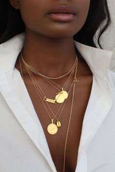 THE JAMAICAN Ackee Coin Necklace is handcrafted from an authentic Jamaican coin using the traditional lost-wax casting technique. The coin was minted during nation's independence era. It features Jamaica's national dish the ackee fruit and the phrase "Let us produce more food" on one side. The other side features the nation's motto "Out of Many, One People" and island's The Coat of Arms honouring the Indigenous people of the region. Metal Info & CareAvailable in: Sterling Silver, 18K Gold Vermei Bean Necklace, African Gold, Sterling Silver Cross Necklace, Lost Wax Casting, Women's Jewelry And Accessories, Coffee Bean, Coin Necklace, Coin Pendant, Jewelry Inspo