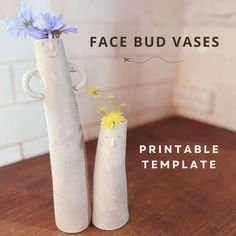 two vases with flowers are sitting on a table