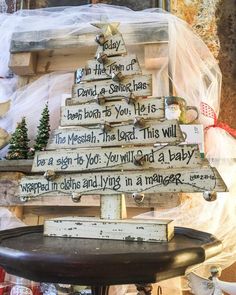 a christmas tree made out of wooden planks with words written on the top and bottom