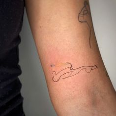 a woman's arm with a tattoo on it that has a line in the middle