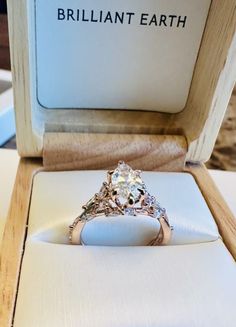 an engagement ring in a box on display