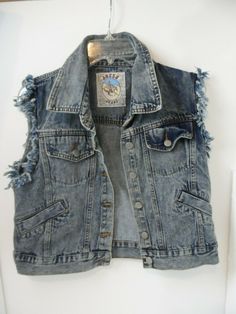 This vest is in good pre-owned condition that shows no stains and rips.  Vest has fringe arms.  Measures from armpit to armpit it is 20".   JE-2 Punk Denim Vest, Distressed Cotton Denim Vest In Washed Blue, Distressed Washed Blue Cotton Denim Vest, Grunge Distressed Cotton Denim Vest, Distressed Denim Blue Cotton Vest, Distressed Blue Denim Vest, Blue Distressed Denim Vest, Trendy Washed Blue Vest, Trendy Blue Washed Vest