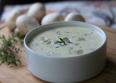 a bowl of soup sitting on top of a wooden table