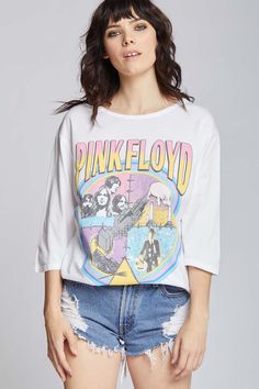 For our Pink Floyd lovers, here is your new favorite band tee! This unique t-shirt features a compilation of artwork from some of their most famous albums including, "Wish You Were Here" and "Animals". Made with soft cotton fabric, 3/4 sleeves, a crewneck collar, and loose comfortable fit. Details Style #301982 Color: White Pink Floyd Vintage Style 3/4 Sleeve Oversized T-Shirt 100% Cotton Care/Import Machine Wash Cold, Tumble Dry Low Designed and Finished in Los Angeles Measurements Model is wea Band Merch Cotton Tops With Graffiti Print, Spring Band Merch Tops With Graphic Design, Band Merch Tops With Screen Print For Fans, Alternative Style Graphic Print Tops For Fans, Pop Culture Screen Print Tops For Concerts, Spring Band Merch Tops With Band Logo, Spring Band Logo Merch Tops, Alternative Style Graffiti Print Top For Fan Merchandise, Alternative Style Graffiti Print Top For Fans