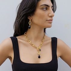 "A beautiful gold chain necklace with a black crystal pendant. With unique eye shaped links this gold toggle necklace is easy to match and will upgrade any outfit! *   *   *   *   *   *   *   *   *   *   *   *   * Materials: 24 k gold plated brass chain and elements - matte finish  Black teardrop crystal Measurements: Chain width: 0.4\"/1.cm Clasp diameter: 0.94\"/2.4 cm Drop (total): 2''/5cm Thickness: 0.12\"/3 mm Crystal length: 0.87\"/2.2 cm Crystal width: 0.51\"/1.3 cm For matching earrings Thick Gold Necklace, Gold Bib Necklace, Abstract Necklace, Chunky Gold Necklaces, Statement Necklace Gold, Bold Statement Necklaces, Gold Chain Choker, Chunky Statement Necklace, Toggle Necklace