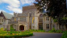 a large castle like building surrounded by lush green trees