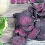 purple beets sitting on top of a wooden table next to lettuce and an eggplant