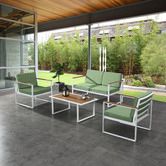 an outdoor patio with green cushions and white furniture on concrete flooring, surrounded by greenery