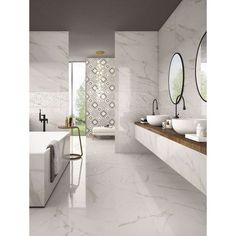 a bathroom with white marble walls and flooring, two sinks on the left side