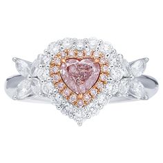 a pink diamond heart ring with white and yellow diamonds in the center, surrounded by leaves